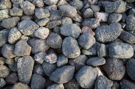 Old weathered gray cobble stones in a heapの写真素材