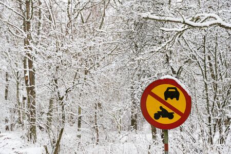Roadsign, no cars or motorcycles in a snowy forestの写真素材