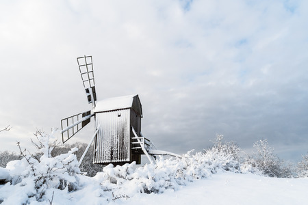 Old wooden windmill view in a snowy landscape at the swedish island Oland, the island of sun and windの写真素材