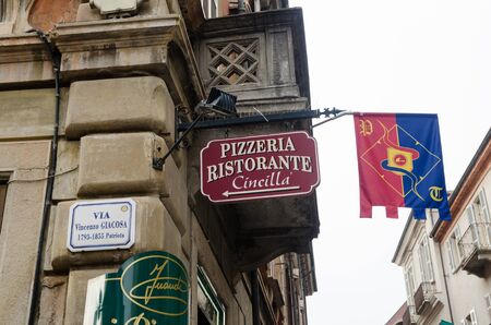 Alba, Italy - October 1, 2018: Street corner with beautiful signs and flag in the historic city of Alba in Piedmont in Italyのeditorial素材