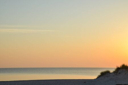 Colorful sky by a sandy beach by sunset at the swedish island Gotland