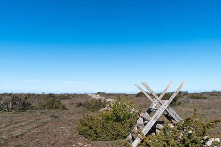 Traditional wooden stile by an old dry stone wall on the island Oland in Swedenの写真素材