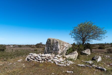 Ancient shepherds shelter by a big rock in a barren landscape on the swedish island Olandの写真素材