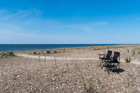 Summer view with two empty chairs by the coast of the Baltic Sea on the island Oland in Swedenの写真素材