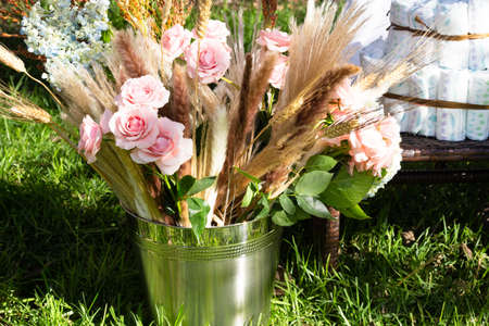 babyshower bucket with flowers bouquet and diapersの写真素材