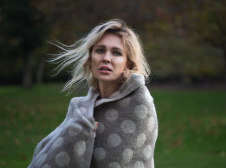 beautifil one woman in park dansing  in plaid or blanketの写真素材