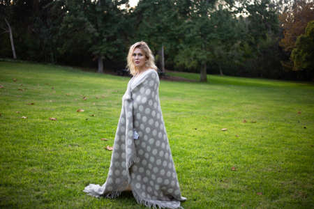 beautifil one woman in park dansing  in plaid or blanketの写真素材