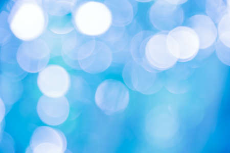 Blue and white bokeh background from natural forestの写真素材
