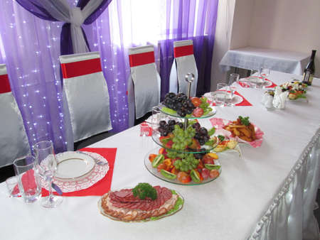 Wedding table with snacks and decor in red and whiteの写真素材