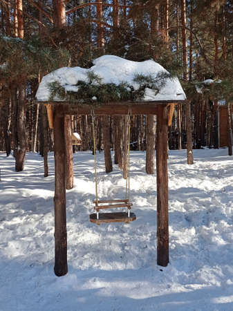 Swing in the winter forestの写真素材
