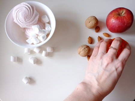 Sweets and fruits. Choosing the right food. Refusal of sweets.の写真素材