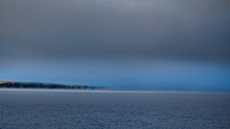 When the temperature is zero degrees C and the fog remains on the lakeの写真素材