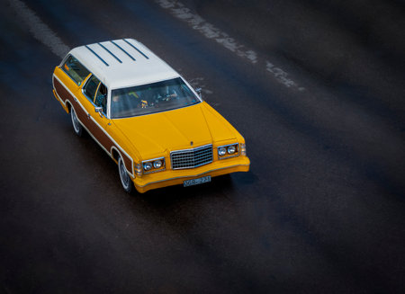 Retro yellow car on the road in the city. Photo in old color image styleのeditorial素材