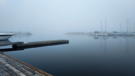 Early morning at the lake Vasman boat harbor when the fog has not lifted from the water.の写真素材