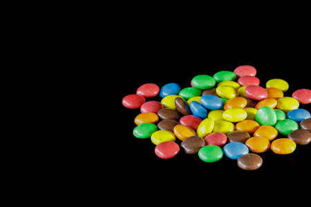 Colorful chocolate candies on a black background. Studio shot.のeditorial素材
