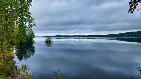 Autumn landscape with lake, forest and cloudy sky. Autumn landscape with lake and forest.の写真素材