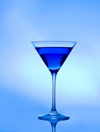 blue drink  on a blue background in a cocktail or martini glassの写真素材
