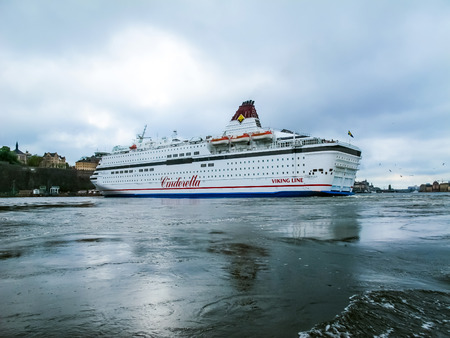 Stockholm / Sweden - May 15 2011: Viking Line cruise ship Cinderella with flag of Sweden turning and leaving port of Stockholm.のeditorial素材