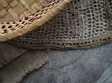 Background from cross section of tree trunk, natural linen napkins and a straw basketの写真素材