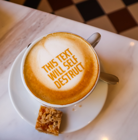 White cup of coffee with text on marble background. Table setting in the restaurantの写真素材