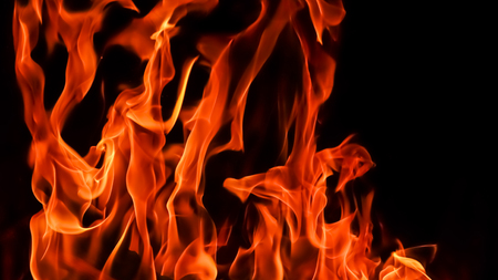 Flames of fire on a black background. The mystery of fire.の写真素材