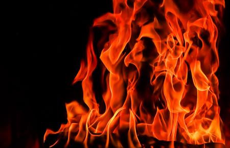 Flames of fire on a black background. The mystery of fire.の写真素材