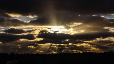 Blue sky and dark clouds with sunlightの写真素材