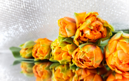 Beautiful orange tulips on the mirror. Perfect for background greeting cardの写真素材