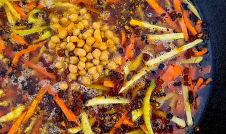 Rice pilaf in a large cast-iron cauldron on fireの写真素材