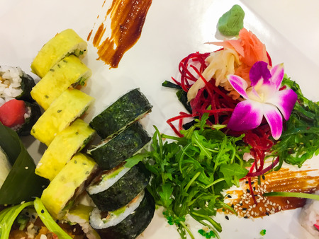 Variety of sushi rolls on a white plateの写真素材