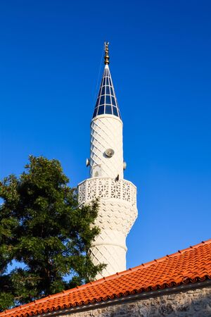 Mosque Minaret on a background of blue sky in Bitez, Bodrum, Turkeyの写真素材