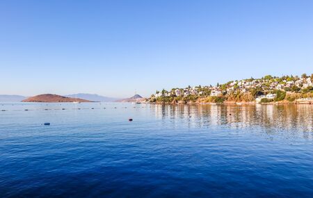 Aegean coast with marvelous blue water, islands, mountains and small white housesの写真素材