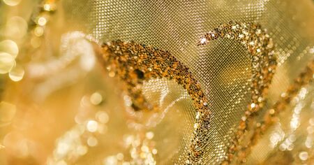 Golden abstract blur defocused background. Concept for New Years Eve, Christmas and happy holidays.の写真素材