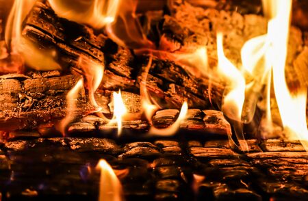 Flames of fire and hot coals of burned wood in the fireplace. Space for copy, text, your words....