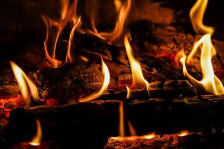 Flames of fire and hot coals of burned wood in the fireplace. Space for copy, text, your words. Horizontalの写真素材