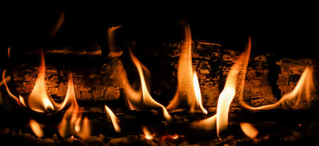 Flames of fire and hot coals of burned wood in the fireplace. Space for copy, text, your words. Horizontalの写真素材