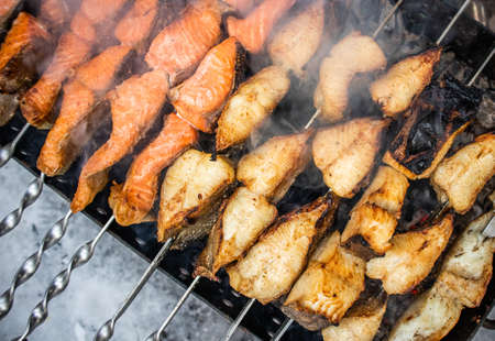 Fish kebab on skewers on the grill in winter. Salmon and halibutの写真素材
