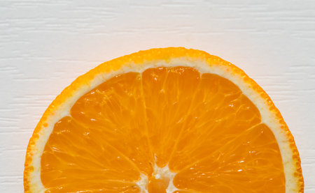 Part of an orange slice on a white background. Place for your textの写真素材