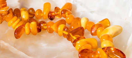 Solar beads of fiery amber on onyx marble background. Natural stone backdrop.の写真素材