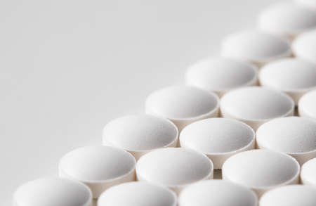 Rows of pills on a white background. Health care, medicine, pharmacy and disease conceptの写真素材