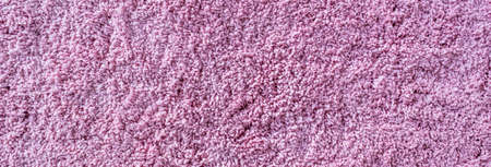 Long pile carpet texture. Abstract background of shaggy pink fibers.の写真素材