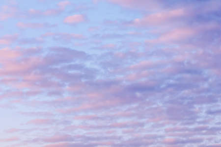 Background of blue sky with pale pink clouds in sunset