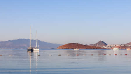 Beautiful sunrise on the Aegean Sea with islands, mountains and boats. High quality photoの写真素材