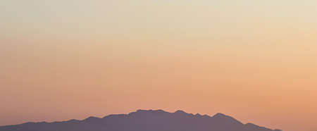 Background from a beautiful colorful sunset with the silhouette of the mountains. High quality photo