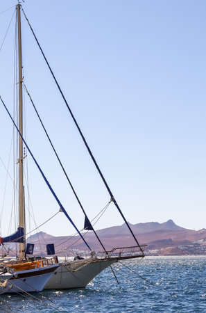 Sailboats in the blue sea against the backdrop of islands and mountains. Sports and summer vacations...