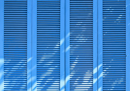 Texture of vintage blue door. Background of classic louver with horizontal wooden pattern.の写真素材