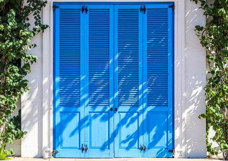 Texture of vintage blue door. Background of classic louver with horizontal wooden pattern.