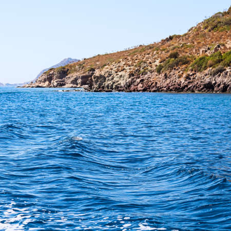 Blue sea waves, beautiful natural rocky seashore and islands. Summer vacation and coastal nature conceptの写真素材