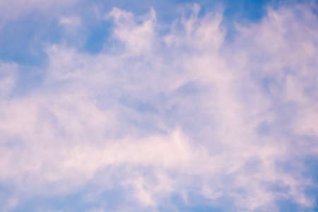 Background of a beautiful pink and pale purple sky with clouds at sunsetの写真素材
