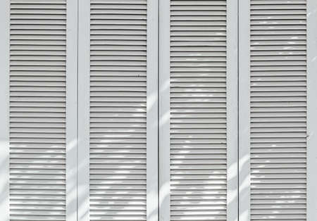 Texture of vintage white door. Background of classic louver with horizontal wooden pattern.の写真素材